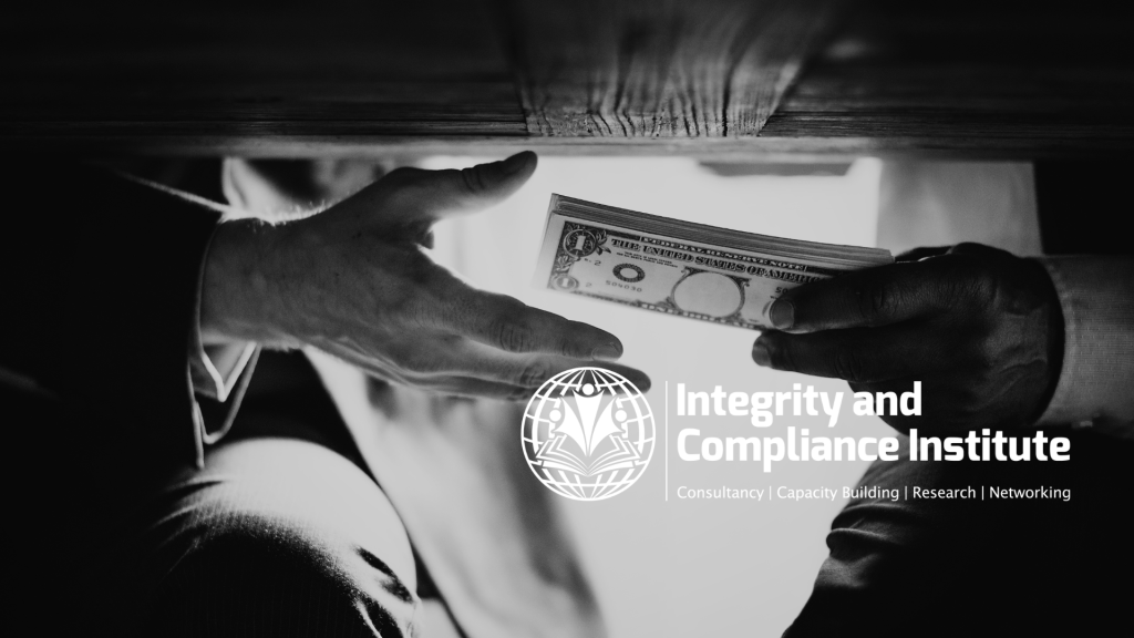 Two hands exchanging a folded bundle of banknotes beneath a desk, photographed in black and white.